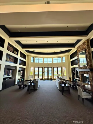 a living room with furniture gym equipment and a large window