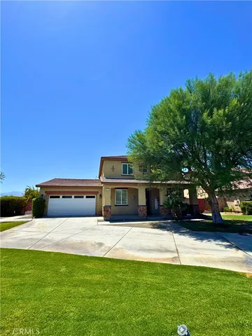 a view of house with yard and outdoor seating