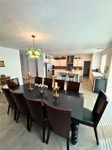 a dining room with furniture and a wooden floor