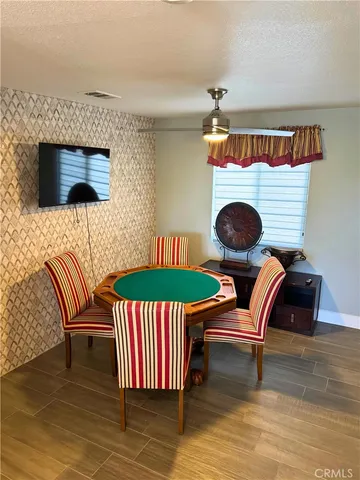 a dining room with furniture and wooden floor