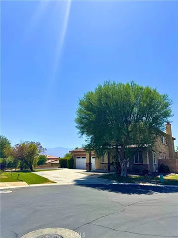 a view of street with house in background