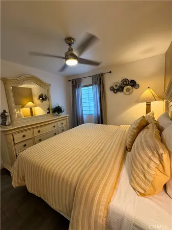 a bedroom with a bed and dresser with mirror