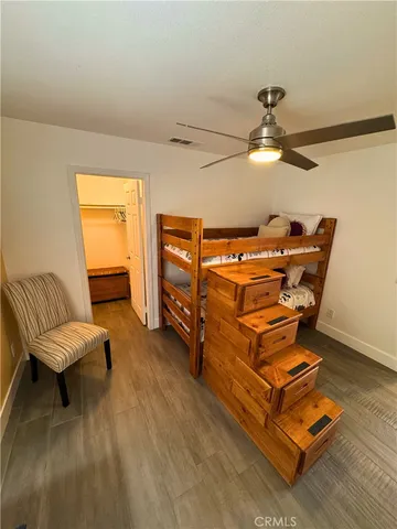 a room with wooden floor and furniture