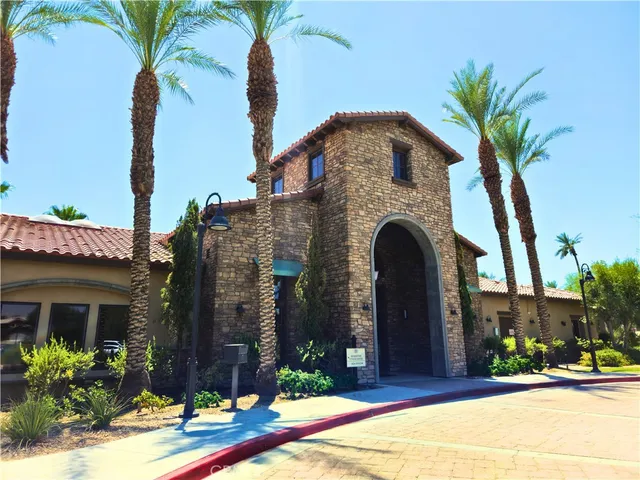 a front view of a building with a garden