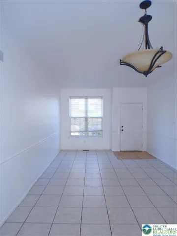 a white toilet sitting next to a white sink and vanity