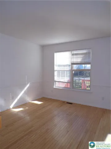 a kitchen with granite countertop white cabinets and a stove