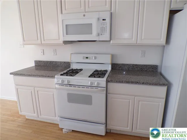 a kitchen with granite countertop a sink and a vanity