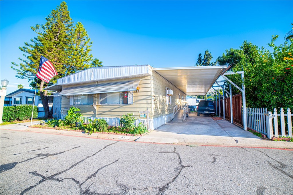 a view of a house with a yard and potted plants
