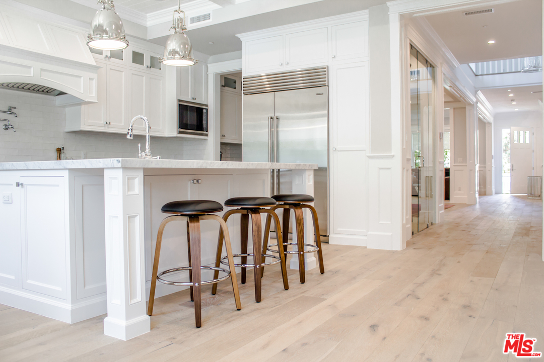 15714 Morrison Street Encino, CA 91436 - Photo 20 of 49 a kitchen with cabinets and stainless steel appliances