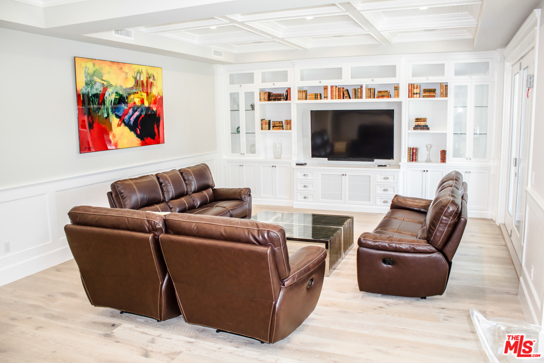 15714 Morrison Street Encino, CA 91436 - Photo 26 of 49 a living room with furniture a flat screen tv and a fireplace