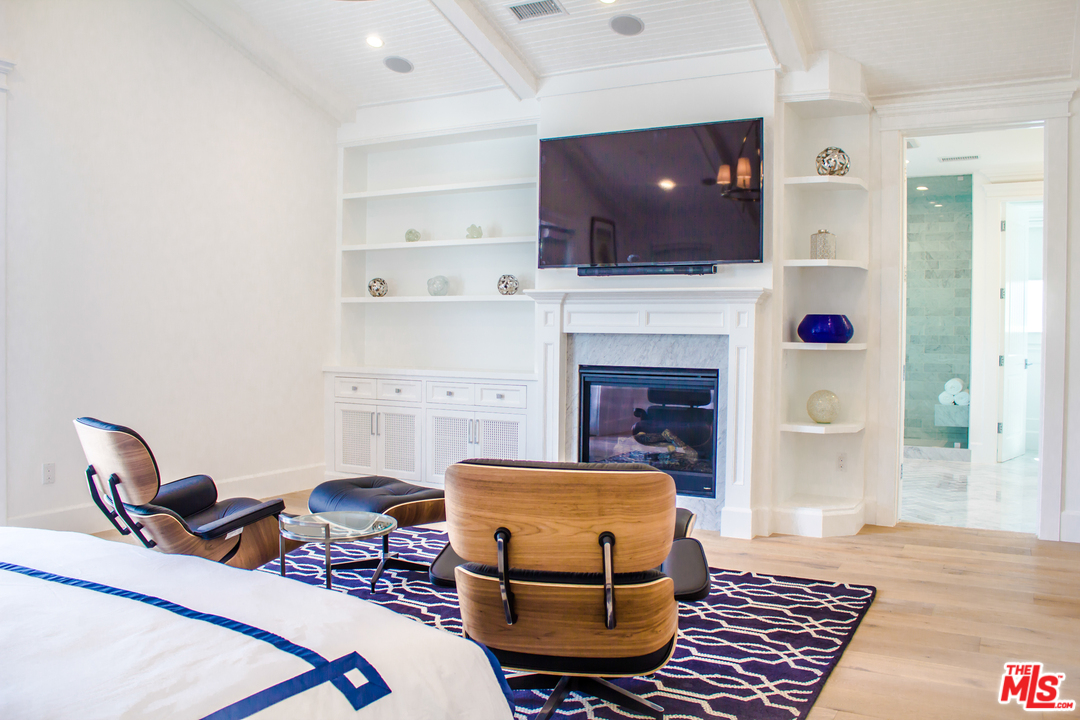15714 Morrison Street Encino, CA 91436 - Photo 32 of 49 a living room with furniture a flat screen tv and kitchen view