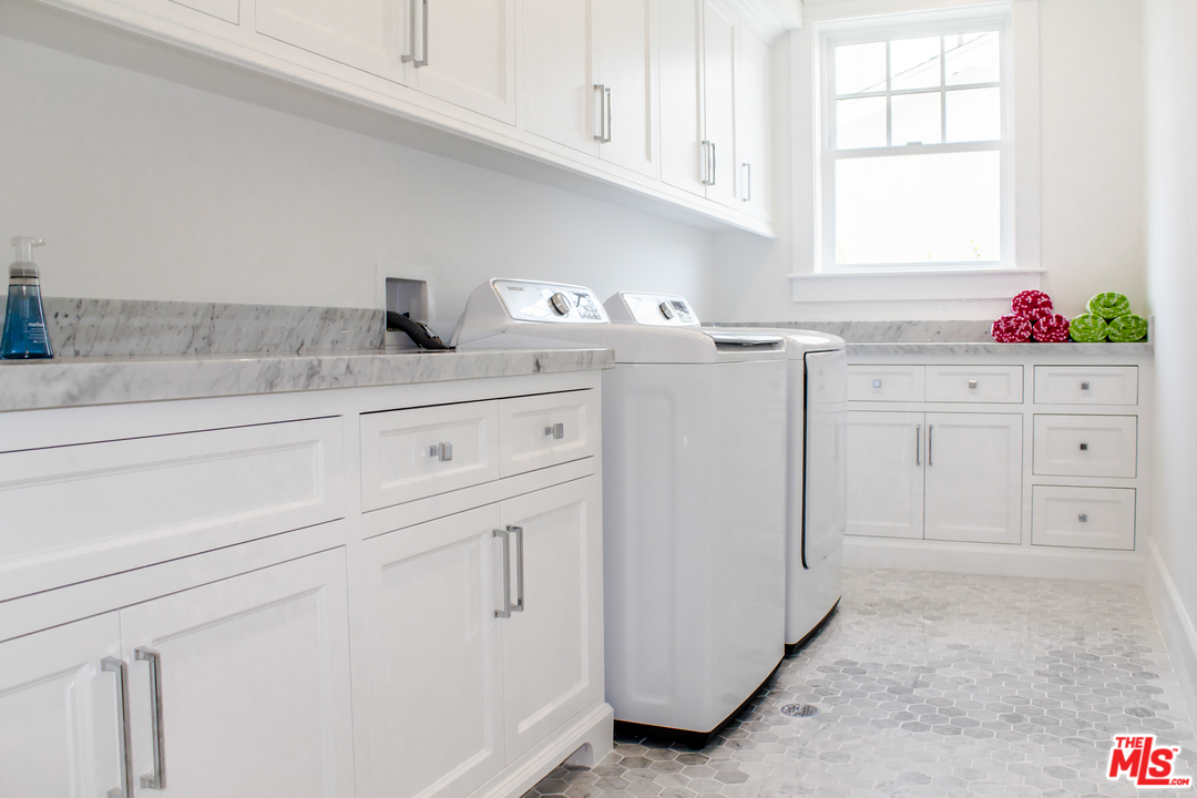 15714 Morrison Street Encino, CA 91436 - Photo 38 of 49 a kitchen with white cabinets and white appliances