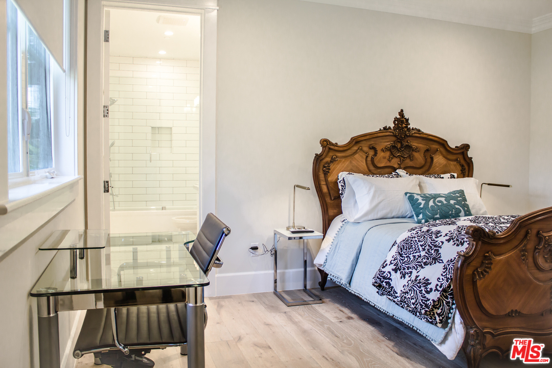 15714 Morrison Street Encino, CA 91436 - Photo 41 of 49 a bedroom with a bed and wooden floor