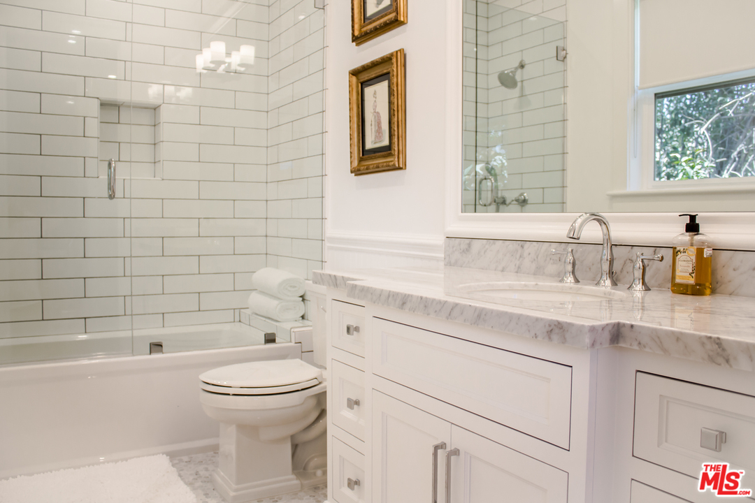 15714 Morrison Street Encino, CA 91436 - Photo 42 of 49 a bathroom with a sink a toilet and shower