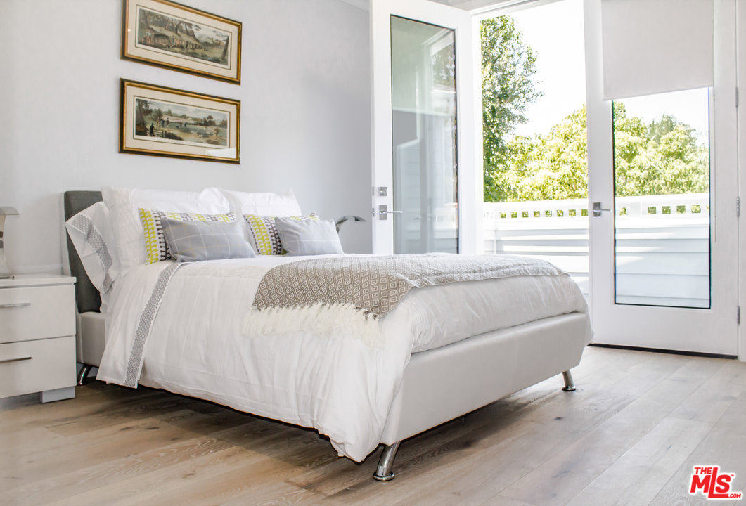 15714 Morrison Street Encino, CA 91436 - Photo 43 of 49 a bedroom with a bed and a large window