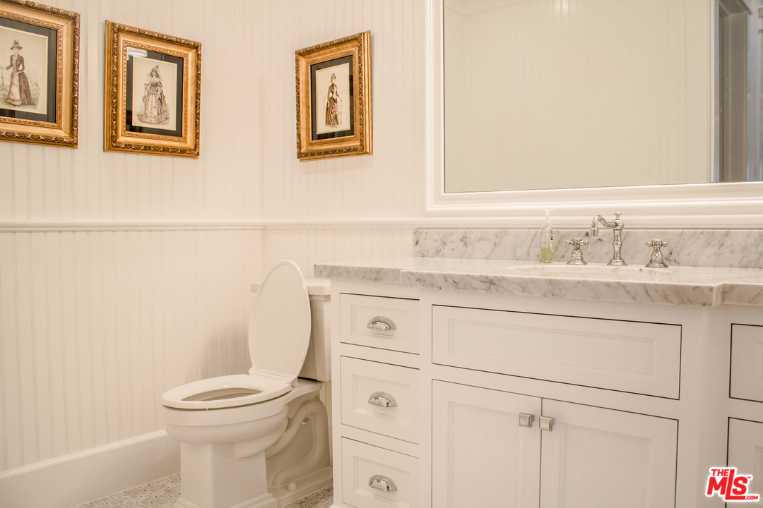 15714 Morrison Street Encino, CA 91436 - Photo 47 of 49 a bathroom with a sink mirror vanity and toilet