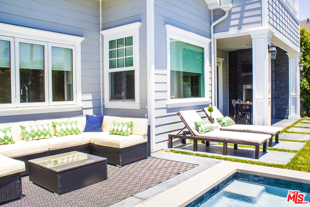 15714 Morrison Street Encino, CA 91436 - Photo 49 of 49 a view of a patio with couches table and chairs and potted plants