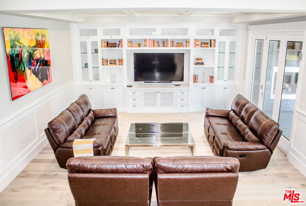 15714 Morrison Street Encino, CA 91436 - Photo 5 of 49 a living room with furniture a flat screen tv and a fireplace