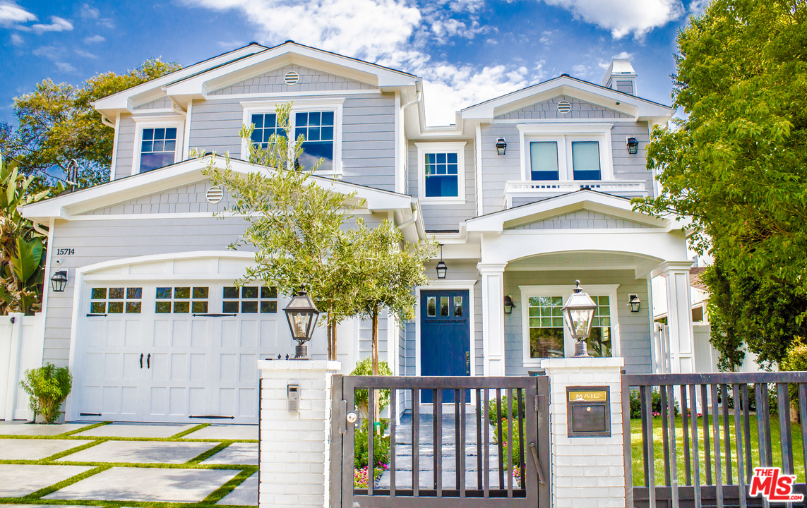 15714 Morrison Street Encino, CA 91436 - Photo 10 of 49 a front view of a house with glass windows and plants