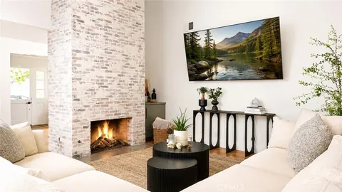 a bathroom with a tub sink vanity and mirror