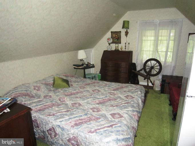 634 Murdock Road Baltimore, MD 21212 - Photo 14 of 23 a bed sitting in a bedroom next to a window with pc on it