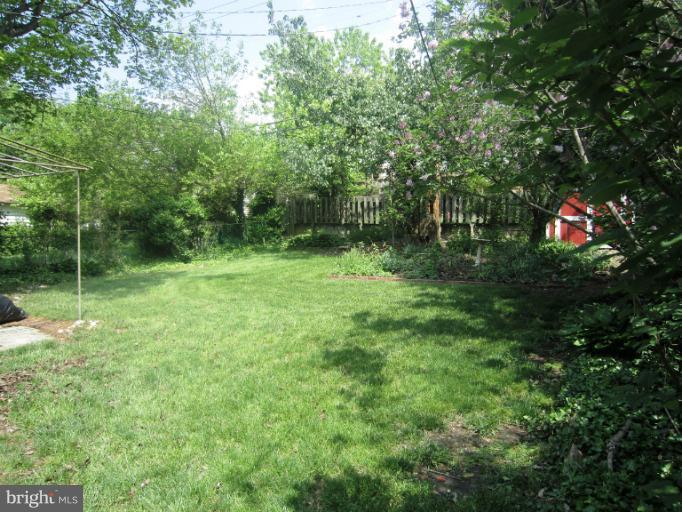 634 Murdock Road Baltimore, MD 21212 - Photo 21 of 23 a backyard of a house with lots of green space and a fountain