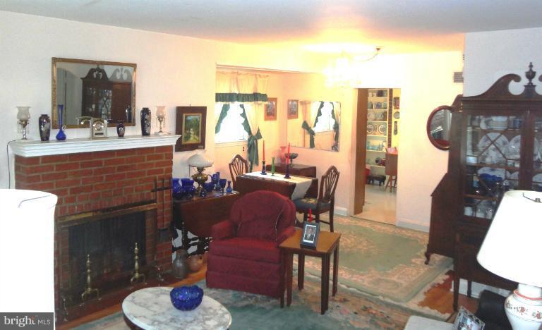 634 Murdock Road Baltimore, MD 21212 - Photo 23 of 23 a dining room with furniture a fireplace and a chandelier