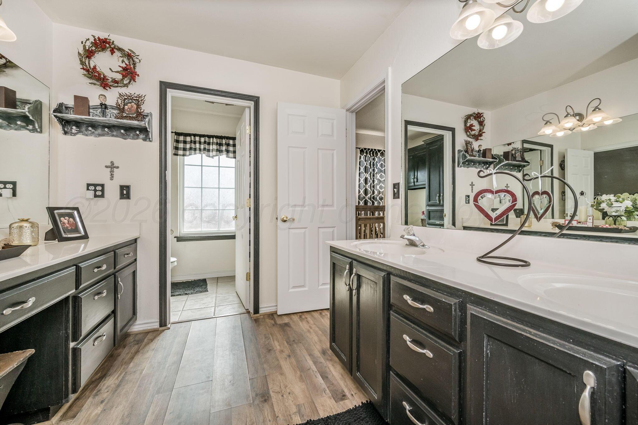 200 Hunters Trail Amarillo, TX 79124 - Photo 17 of 23 a spacious bathroom with a granite countertop sink a mirror and a shower