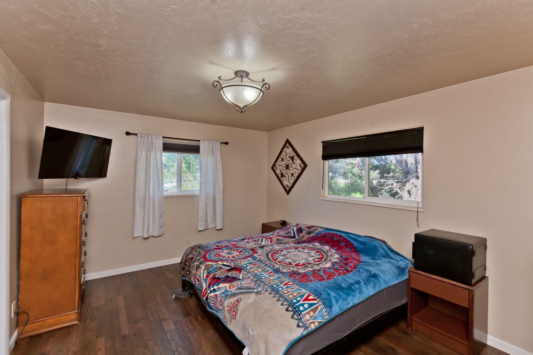 498 Sheldon Road Grand Junction, CO 81504 - Photo 21 of 42 a bedroom with a bed and wooden floor