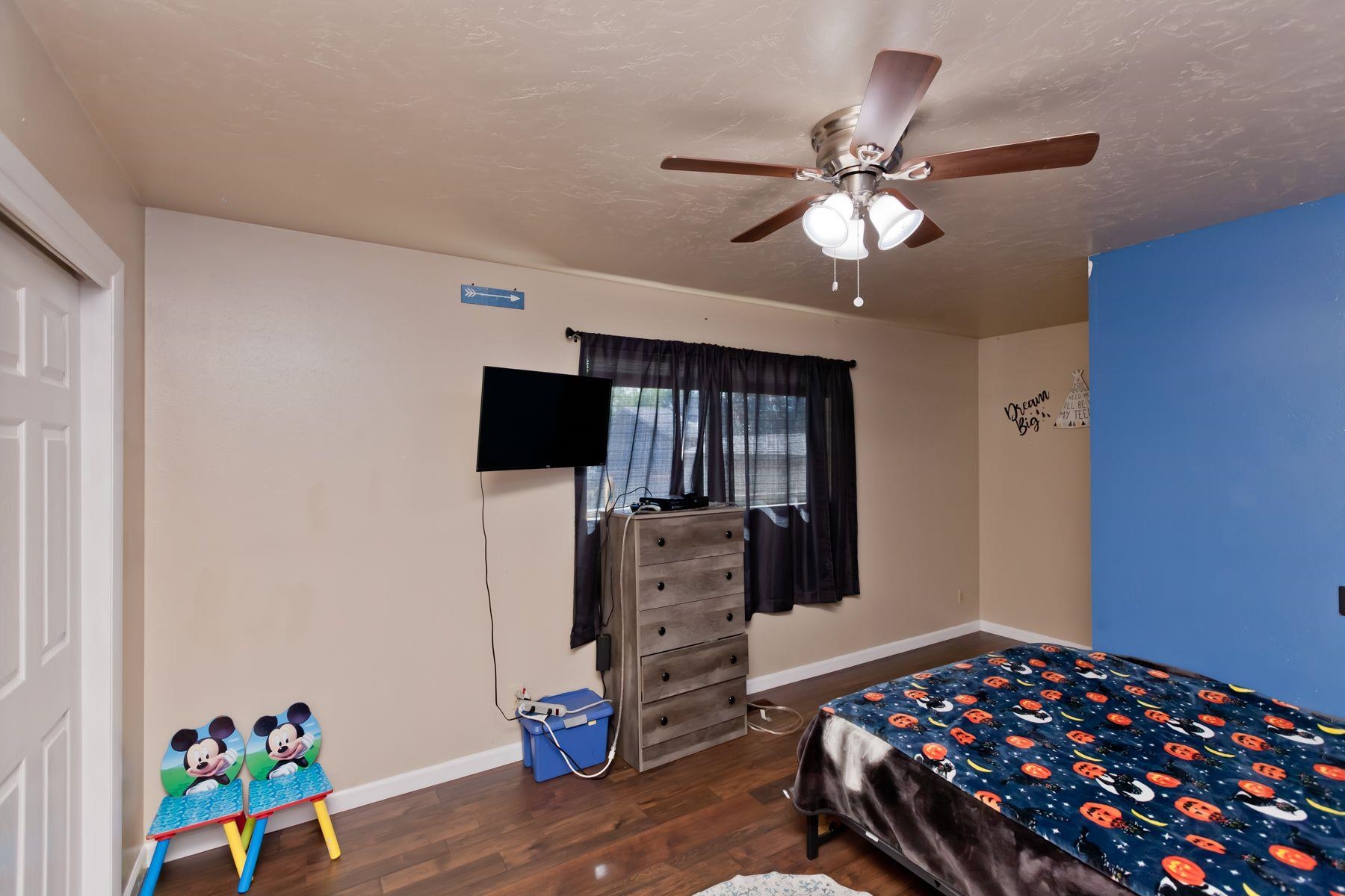 498 Sheldon Road Grand Junction, CO 81504 - Photo 27 of 42 a bedroom with a bed and a flat screen tv