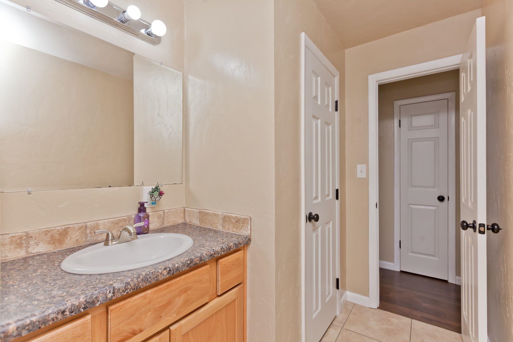 498 Sheldon Road Grand Junction, CO 81504 - Photo 32 of 42 a bathroom with a granite countertop sink and a mirror
