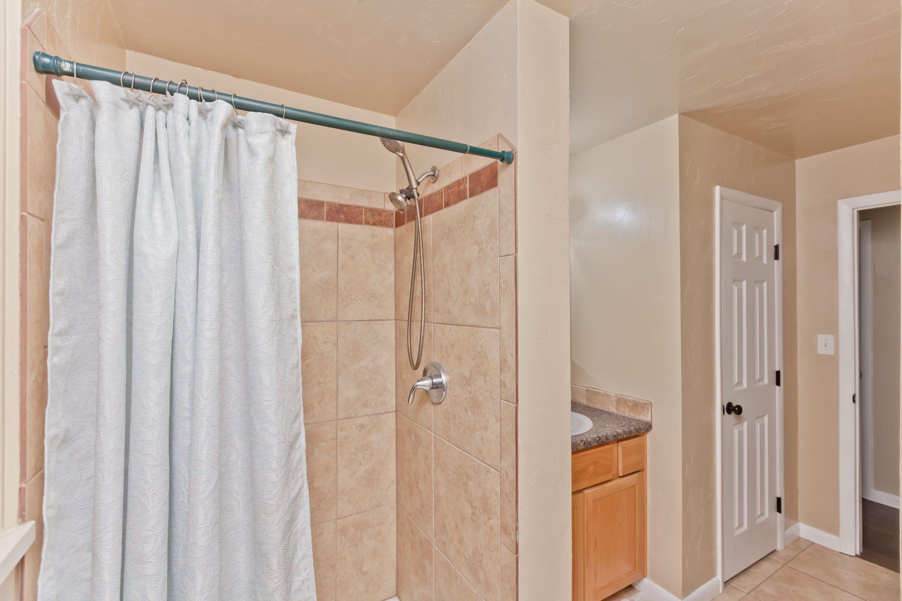 498 Sheldon Road Grand Junction, CO 81504 - Photo 33 of 42 a bathroom with a shower and a glass door