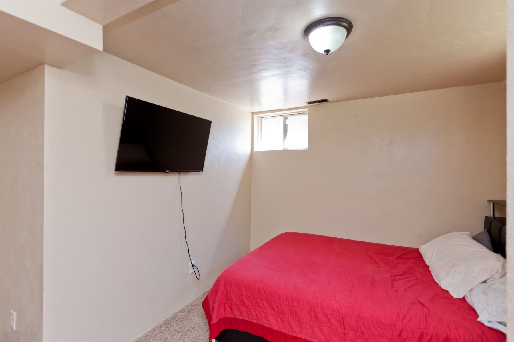 498 Sheldon Road Grand Junction, CO 81504 - Photo 38 of 42 a bedroom with a bed and a flat screen tv