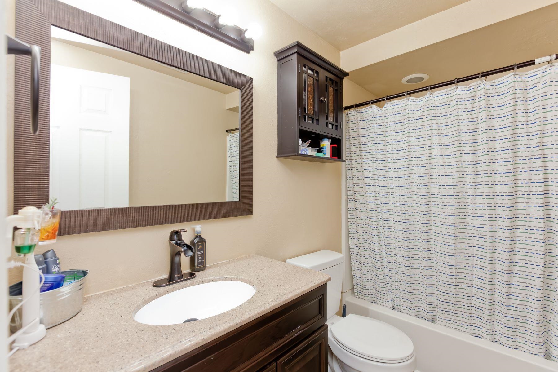 498 Sheldon Road Grand Junction, CO 81504 - Photo 39 of 42 a bathroom with a granite countertop toilet sink and mirror