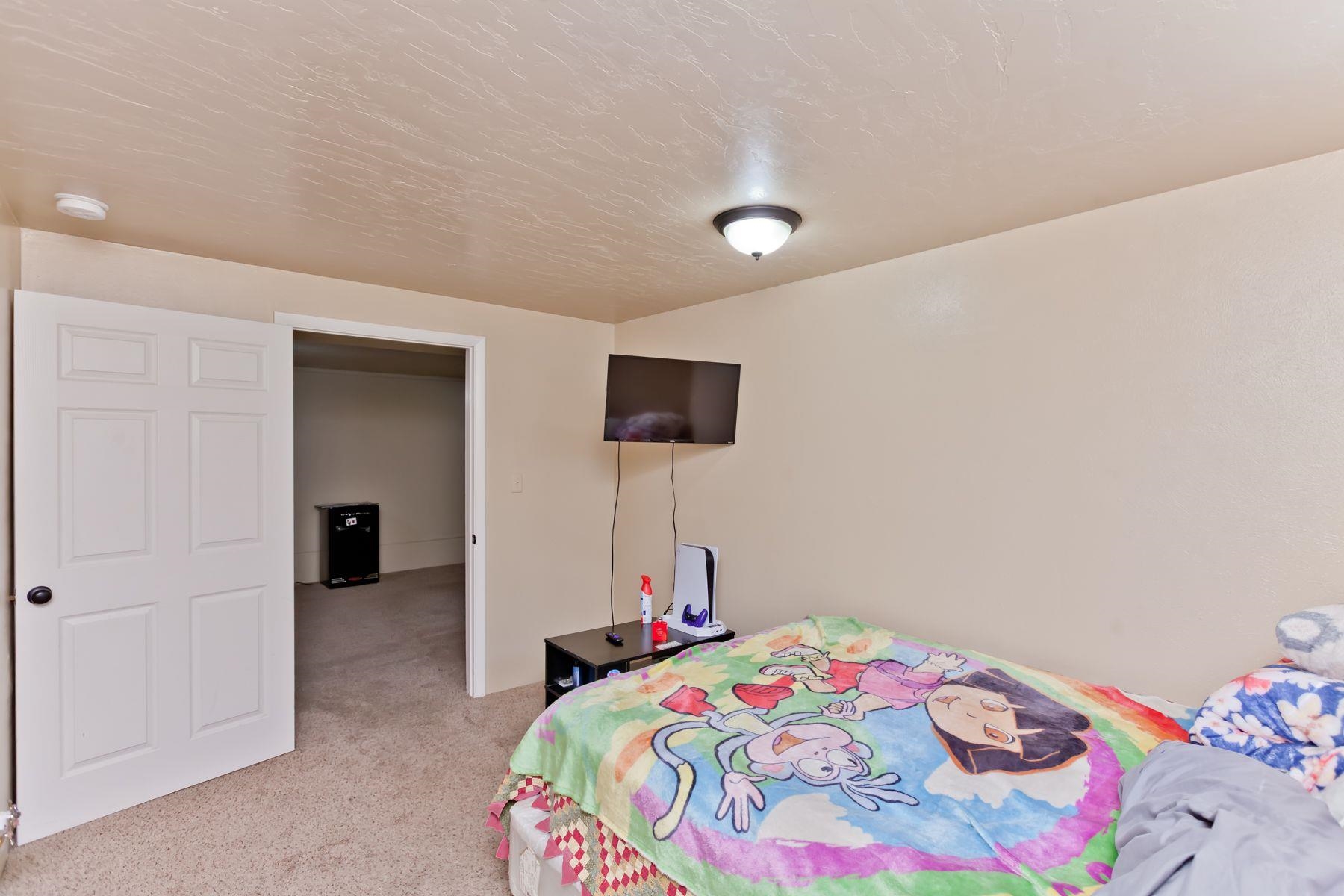 498 Sheldon Road Grand Junction, CO 81504 - Photo 40 of 42 a bedroom with a bed and a tv