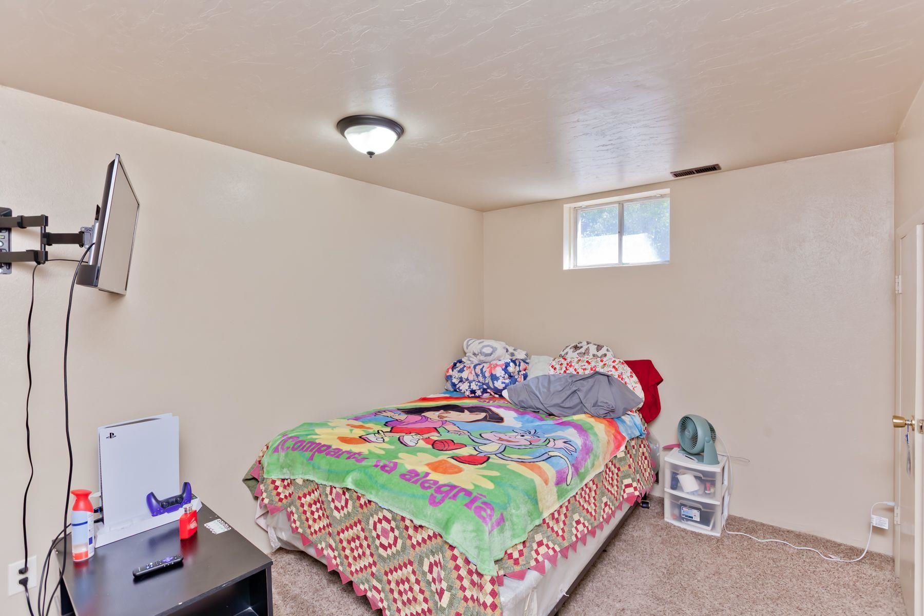 498 Sheldon Road Grand Junction, CO 81504 - Photo 41 of 42 a bedroom with a bed and a dresser