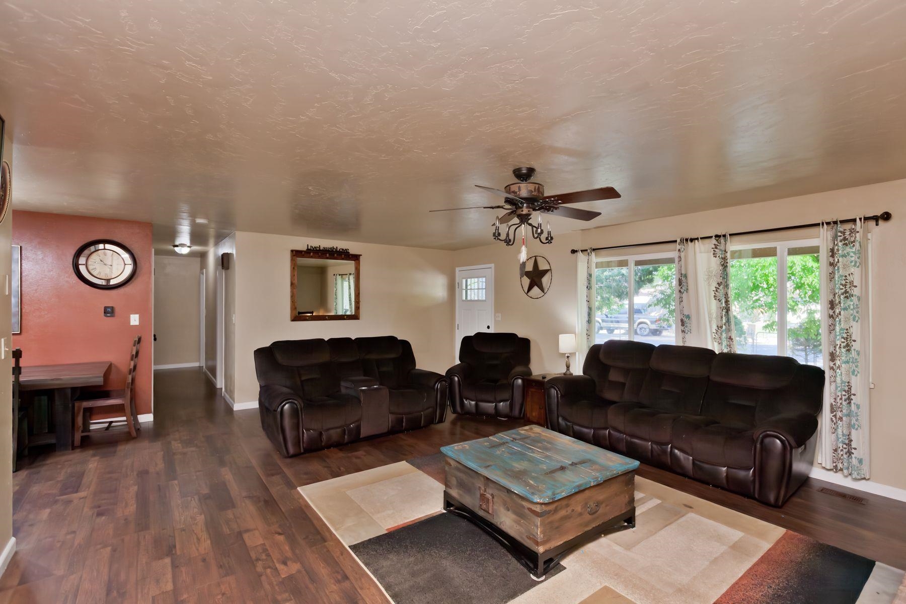 498 Sheldon Road Grand Junction, CO 81504 - Photo 9 of 42 a living room with furniture ceiling fan and a window