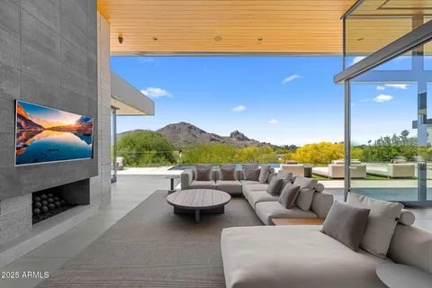 a living room with furniture and painting on the wall