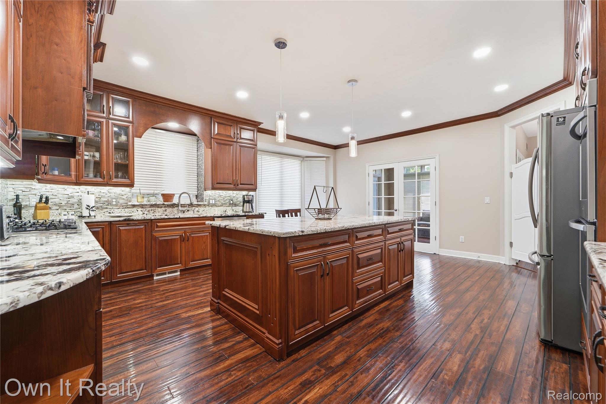 48280 Gladstone Road Canton, MI 48188 - Photo 20 of 59 Kitchen featuring wood-finish flooring, recessed lighting, and a central island with a light-toned countertop