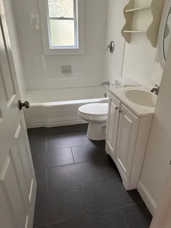 a bathroom with a sink a toilet and a bathtub