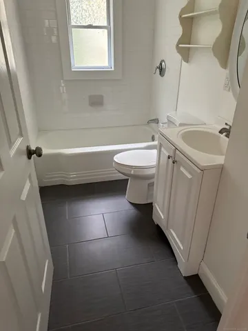 a bathroom with a sink a toilet and a bathtub