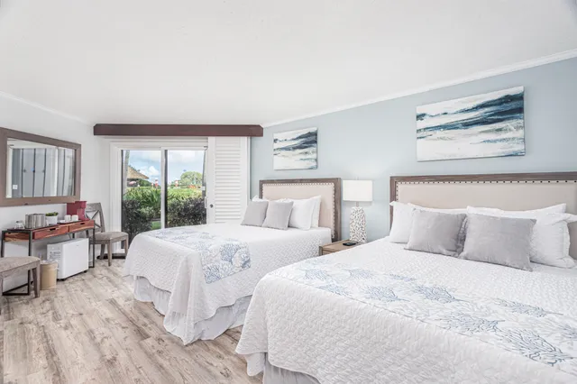 a bedroom with a large bed and a large window