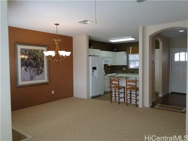 a view of a livingroom with furniture and chandelier