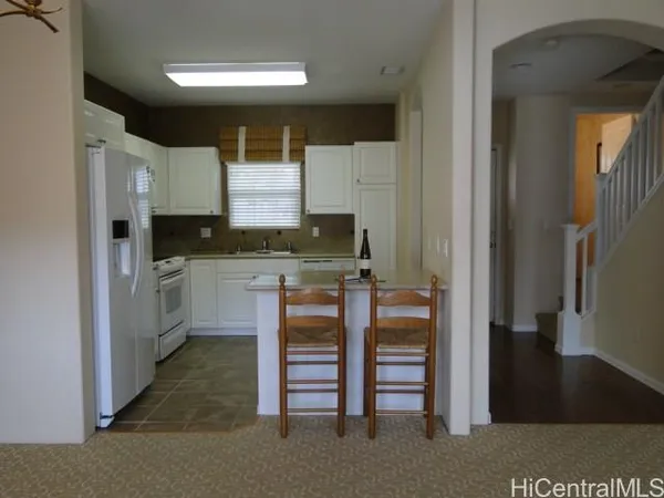 a kitchen with stainless steel appliances a sink and cabinets