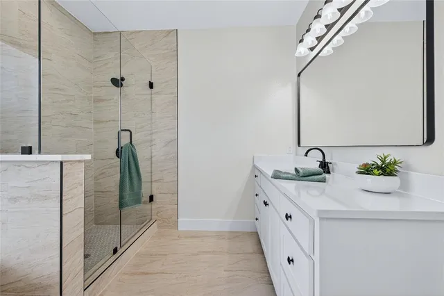 a bathroom with a double vanity sink and a shower