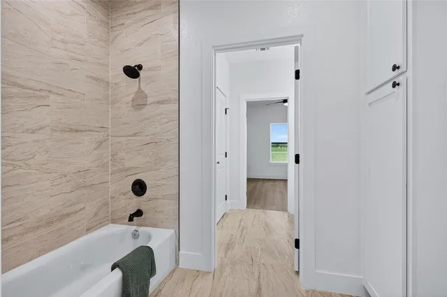 a bathroom with a tub and shower