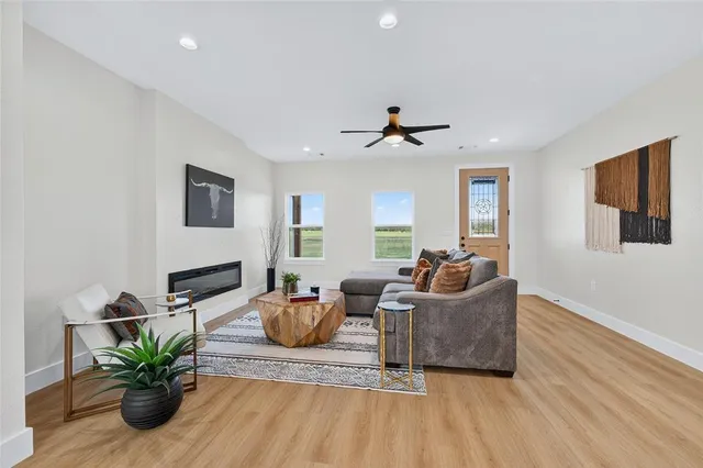 a living room with furniture potted plant and flat screen tv
