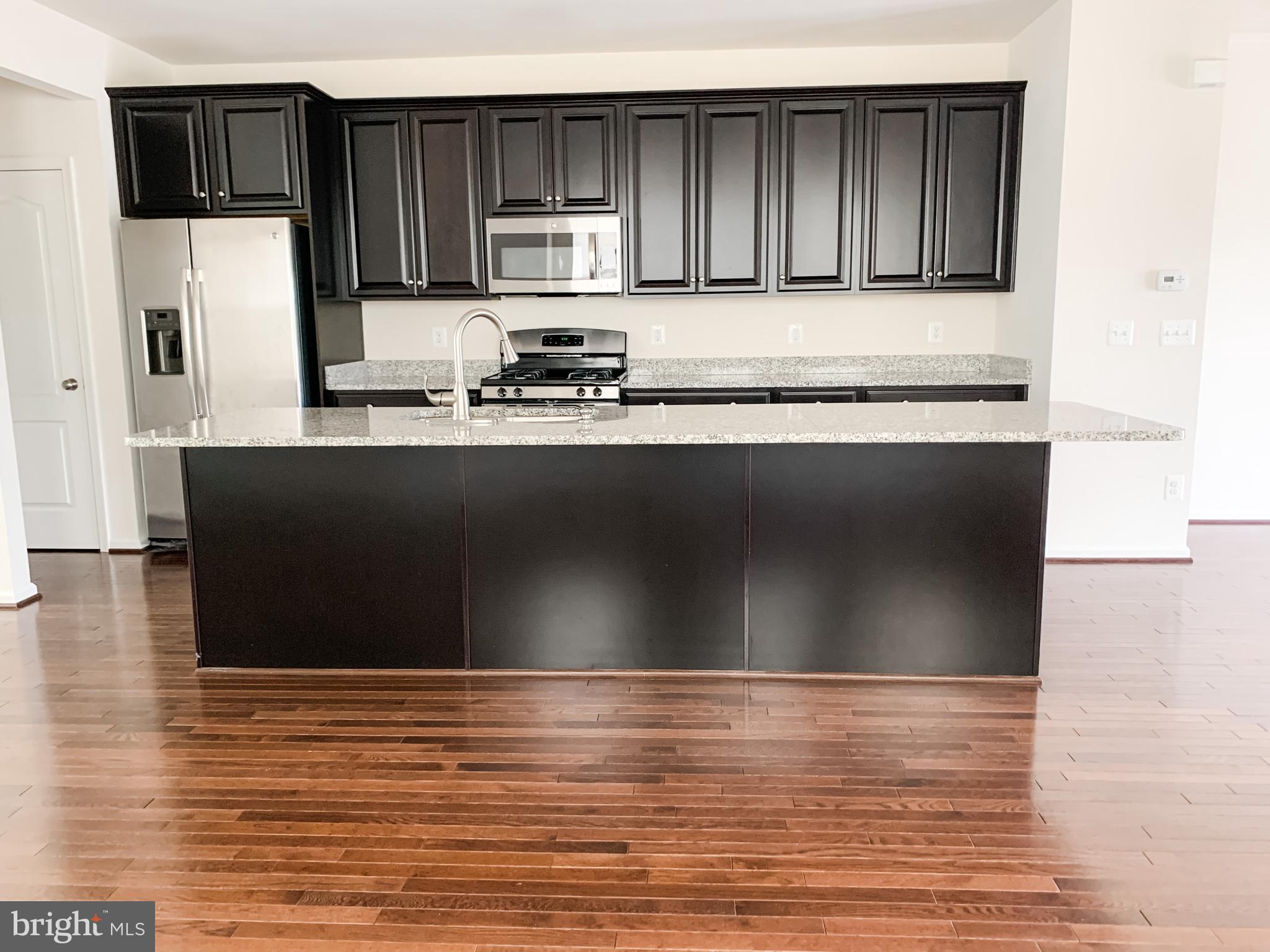 43322 Novi Terrace Ashburn, VA 20147 - Photo 11 of 19 a view of kitchen with stainless steel appliances wooden cabinets and a counter top space
