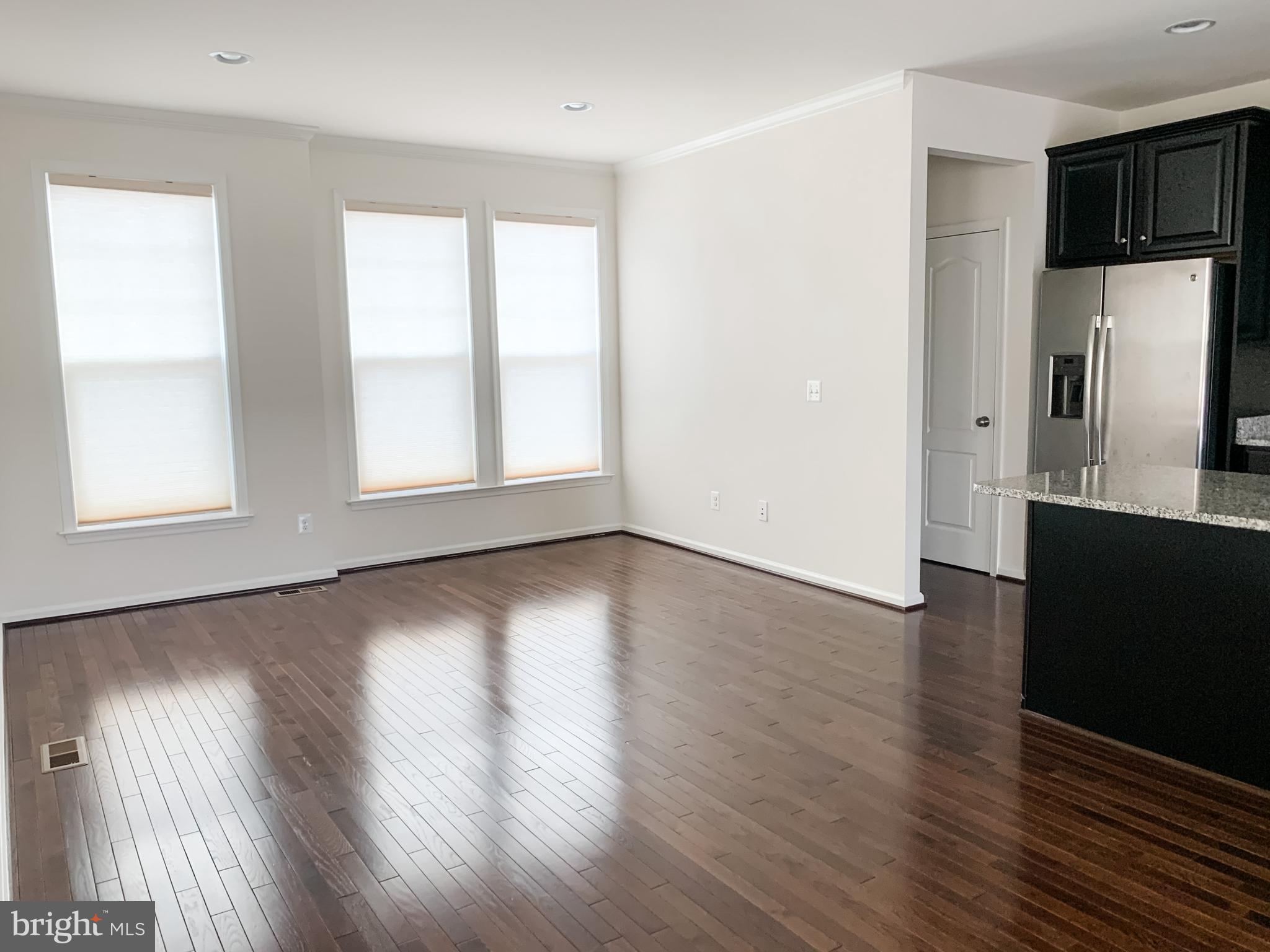 43322 Novi Terrace Ashburn, VA 20147 - Photo 12 of 19 an empty room with wooden floor and windows