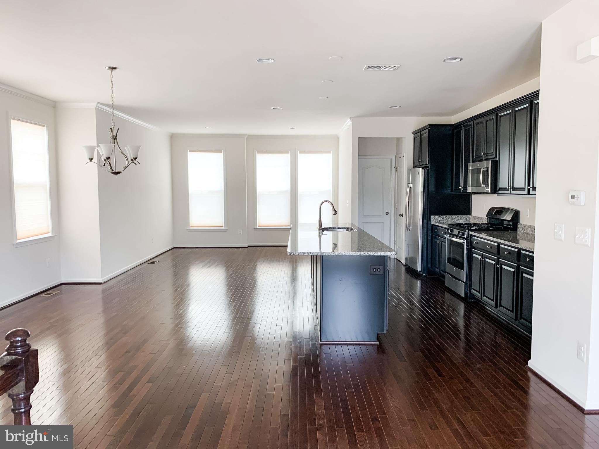 43322 Novi Terrace Ashburn, VA 20147 - Photo 10 of 19 a view of a kitchen with a sink cabinets and wooden floor